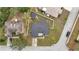An aerial view shows a home with a new roof and fenced yard; showcases nearby road at 112 Lake Butler Ave, Haines City, FL 33844