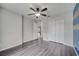 Spacious bedroom with wood-look flooring, a ceiling fan, and a large closet at 112 Lake Butler Ave, Haines City, FL 33844