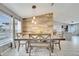 Bright dining room with wood accent wall, tile floor and stylish pendant lights at 112 Lake Butler Ave, Haines City, FL 33844