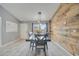 Inviting dining room featuring wood accent wall, pendant lighting and tile floors at 112 Lake Butler Ave, Haines City, FL 33844