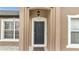 Close up of the Front door with a hanging light and white trim at 112 Lake Butler Ave, Haines City, FL 33844