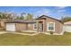 Charming one-story home with a two-car garage, neutral paint, and manicured landscaping at 112 Lake Butler Ave, Haines City, FL 33844