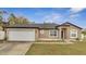 Charming one-story home with a two-car garage, neutral paint and manicured landscaping at 112 Lake Butler Ave, Haines City, FL 33844