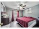 Cozy main bedroom with a ceiling fan, wood-look floors, and ample natural light at 112 Lake Butler Ave, Haines City, FL 33844