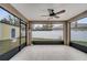 Enclosed patio with tile flooring, ceiling fan, and view of the fenced backyard at 112 Lake Butler Ave, Haines City, FL 33844