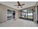 Screened patio with neutral tile flooring, ceiling fan, and a sliding glass door at 112 Lake Butler Ave, Haines City, FL 33844