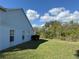 Side yard showcases lush greenery and a spacious lawn at 13900 Corrine Key Pl, Orlando, FL 32824