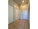 Hallway with tiled floor gives access to multiple rooms at 13900 Corrine Key Pl, Orlando, FL 32824