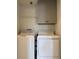 Laundry room featuring a white washer and dryer, overhead cabinets and wire rack shelving for storage at 13900 Corrine Key Pl, Orlando, FL 32824