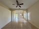 Bright living room features tile flooring, a ceiling fan, and access to the kitchen at 13900 Corrine Key Pl, Orlando, FL 32824