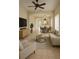Bright living room with neutral decor, tiled floors, ceiling fan, and arched doorway to the dining area at 13900 Corrine Key Pl, Orlando, FL 32824