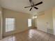 Spacious living room with tile floors, large windows, and a ceiling fan at 13900 Corrine Key Pl, Orlando, FL 32824