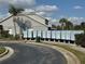 Community mailbox with multiple units, green trash receptacle, landscaped area and residential building in the background at 13900 Corrine Key Pl, Orlando, FL 32824