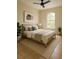 Well-lit bedroom showcasing tile floors, a large arched window, and tasteful decor at 13900 Corrine Key Pl, Orlando, FL 32824