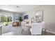 Elegant dining area with white chairs, round table, and access to outdoor space at 1438 Ironbark Bnd, Davenport, FL 33837