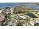 Aerial view of community amenities including pool, tennis courts, and water views at 15165 Heron Hideaway Cir, Winter Garden, FL 34787