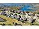 A residential area shows a great view of the neighborhood, with similar two-story homes, swimming pools, and a lake at 15165 Heron Hideaway Cir, Winter Garden, FL 34787