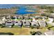 A residential area shows a great view of the neighborhood, with similar two-story homes, swimming pools, and a lake at 15165 Heron Hideaway Cir, Winter Garden, FL 34787