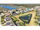 A residential area shows a great view of the neighborhood, with similar two-story homes, swimming pools, and a lake at 15165 Heron Hideaway Cir, Winter Garden, FL 34787