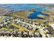 Beautiful aerial view of homes in a lakeside community with lush landscaping and stunning water views at 15165 Heron Hideaway Cir, Winter Garden, FL 34787