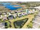 A residential area shows a great view of the neighborhood, with similar two-story homes, swimming pools, and a pond at 15165 Heron Hideaway Cir, Winter Garden, FL 34787