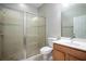 Bathroom featuring a glass-enclosed shower, light wood vanity, and a neutral color scheme at 15165 Heron Hideaway Cir, Winter Garden, FL 34787