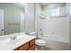 Bathroom featuring a vanity, toilet, and tub with shower and accent tile border at 15165 Heron Hideaway Cir, Winter Garden, FL 34787