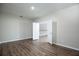 Spacious bedroom with wood-look floors and open doors leading to the upstairs landing at 15165 Heron Hideaway Cir, Winter Garden, FL 34787