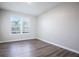 A bright bedroom with wood floors and a window offering natural light at 15165 Heron Hideaway Cir, Winter Garden, FL 34787