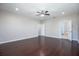 Large bedroom with ceiling fan, hardwood floors, and an en suite bathroom at 15165 Heron Hideaway Cir, Winter Garden, FL 34787