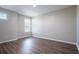Sunlit bedroom with neutral walls, wood-look floors, and large windows at 15165 Heron Hideaway Cir, Winter Garden, FL 34787