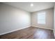Bright, airy bedroom features hardwood floors, fresh paint, and a sun-filled window at 15165 Heron Hideaway Cir, Winter Garden, FL 34787