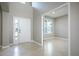 Bright foyer featuring tile floors, a front door with sidelight, and an entryway to another room at 15165 Heron Hideaway Cir, Winter Garden, FL 34787