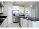 This spacious kitchen features stainless appliances, black countertops, and white cabinets at 15165 Heron Hideaway Cir, Winter Garden, FL 34787