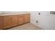 Convenient laundry room with ample cabinet storage and ceramic tile flooring at 15165 Heron Hideaway Cir, Winter Garden, FL 34787