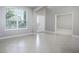 Bright living room with tile floors, a large window, and doorways to the foyer and other rooms at 15165 Heron Hideaway Cir, Winter Garden, FL 34787