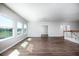Bright living room with wood floors and large windows offering ample natural light at 15165 Heron Hideaway Cir, Winter Garden, FL 34787