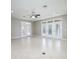 Bright living room with tile floor and multiple sets of French doors leading to the outside at 15165 Heron Hideaway Cir, Winter Garden, FL 34787