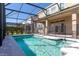 A beautiful screened pool area featuring tile accents and a black safety fence at 15165 Heron Hideaway Cir, Winter Garden, FL 34787