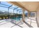 Covered pool area featuring a black safety fence and a black framed screen at 15165 Heron Hideaway Cir, Winter Garden, FL 34787