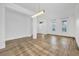 Living room with wood look floor, recessed lights and entry door with sidelight windows at 1555 Lalique Ln, Orlando, FL 32828