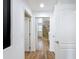 Bright hallway with doorway view of bathroom featuring a glass shower and tile flooring at 1581 Canopy Pasture Dr, St Cloud, FL 34771