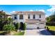 Beautiful two-story home featuring lush landscaping, a barrel tile roof and a three-car garage at 1581 Canopy Pasture Dr, St Cloud, FL 34771