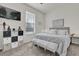 Bedroom with carpet, a bed with throw pillows, a bench, and a wall-mounted TV at 15914 Moonlight Bay St, Winter Garden, FL 34787