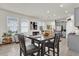Dining room featuring a dark wood table, seating for four, and multiple windows providing natural light at 15914 Moonlight Bay St, Winter Garden, FL 34787