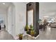 Entry foyer features decor accents and flows to the open-concept living area and kitchen at 15914 Moonlight Bay St, Winter Garden, FL 34787