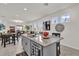 Open kitchen with large island, granite countertops and stainless steel sink and faucet at 15914 Moonlight Bay St, Winter Garden, FL 34787