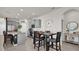Kitchen featuring gray cabinets, stainless appliances, a center island, and a breakfast table with seating for four at 15914 Moonlight Bay St, Winter Garden, FL 34787