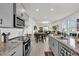 Open concept kitchen features a granite countertop, stainless steel appliances and tile floor at 15914 Moonlight Bay St, Winter Garden, FL 34787