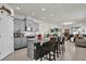 Open kitchen featuring gray cabinets, granite counters, stainless appliances, and an island with bar seating at 15914 Moonlight Bay St, Winter Garden, FL 34787